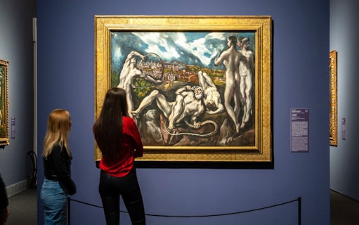 Visitors viewing El Greco painting at Museum of Fine Arts Budapest exhibition.