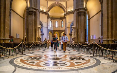 Visitors exploring the interior of Florence Duomo on a guided tour.
