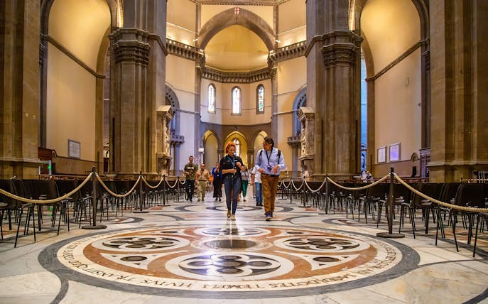 Visitors exploring the interior of Florence Duomo on a guided tour.