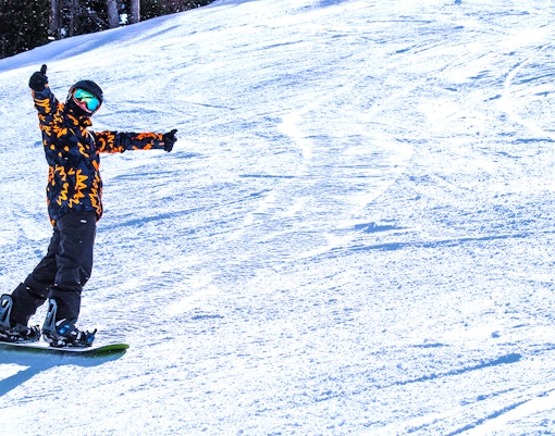 Skiers on snowy slopes at VallNord Ski Resort, Andorra, with mountain backdrop.