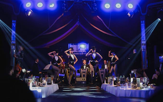 Burlesque performers on stage at a dinner club in Vienna.
