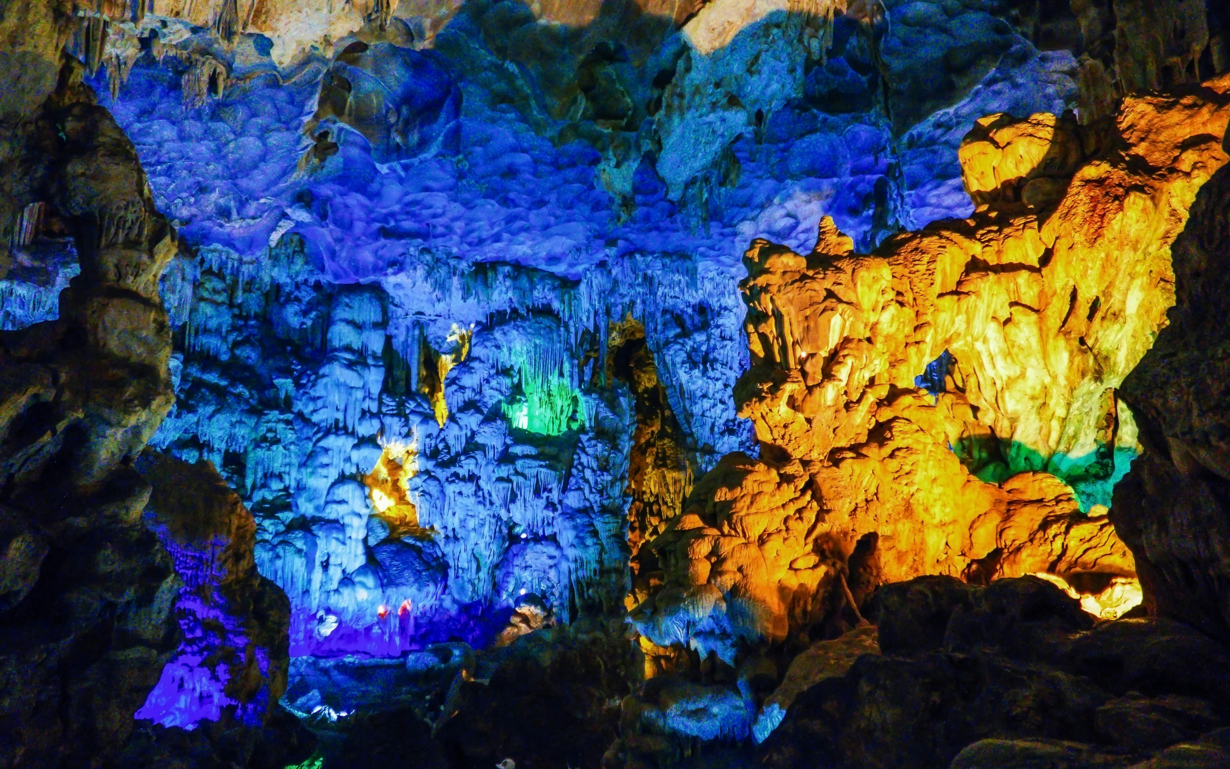 Colourful lights illuminate stalactites in Sung Sot Cave, Ha Long Bay, Vietnam.