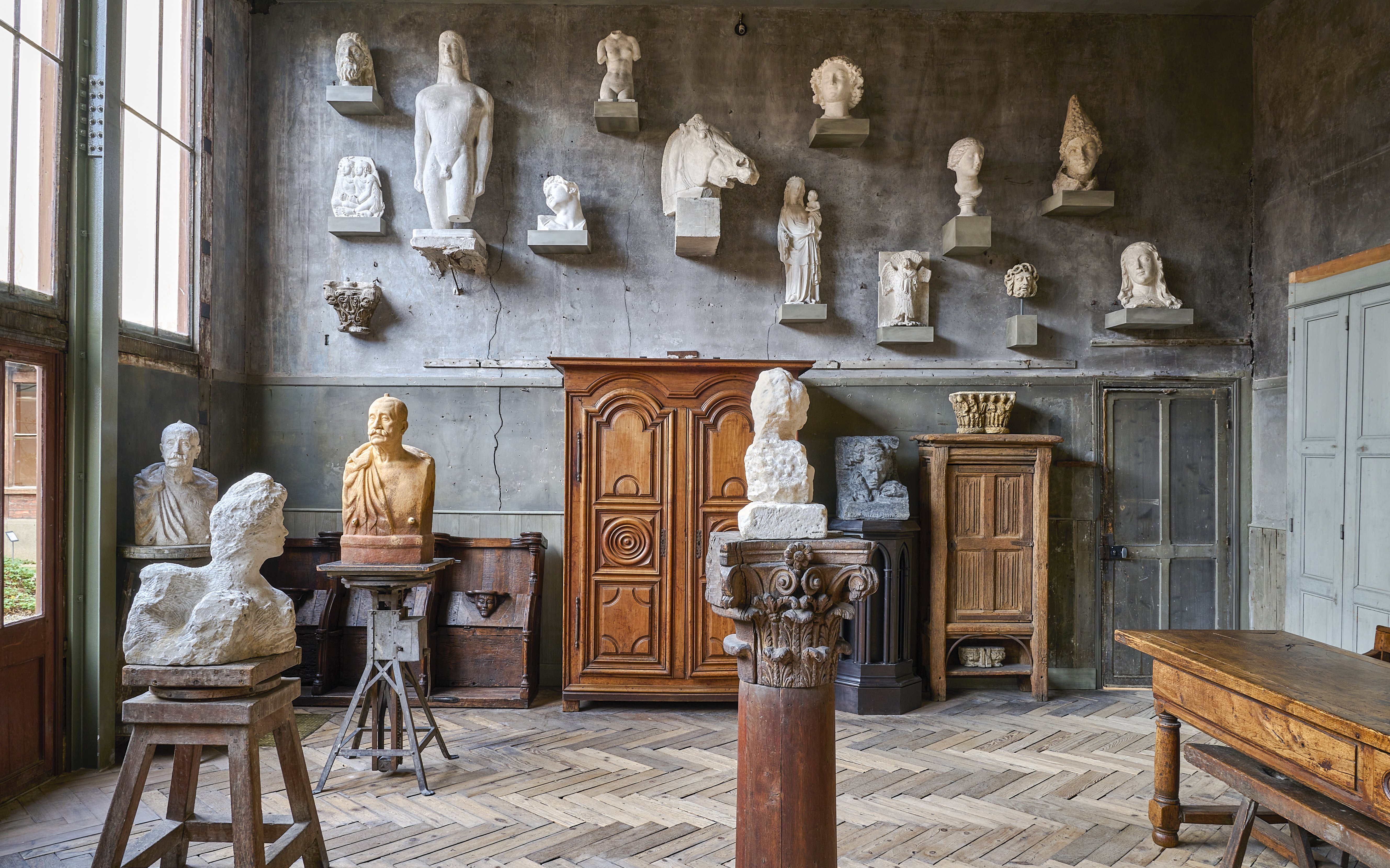 Busts and sculptures displayed in a room at Bourdelle Museum, Paris.