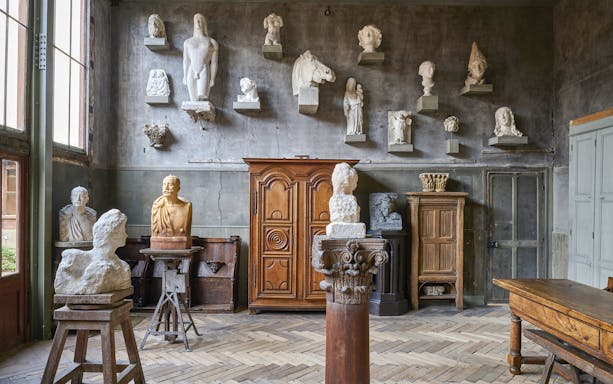 Busts and sculptures displayed in a room at Bourdelle Museum, Paris.