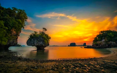 Sunset view of Hong Islands with limestone cliffs and calm sea, Krabi.