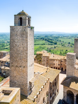 San Gimignano Civic Museum tower with Tuscan countryside in the background.