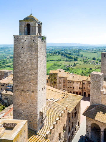 San Gimignano Civic Museum tower with Tuscan countryside in the background.