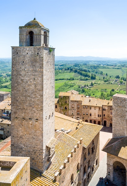 San Gimignano Civic Museum tower with Tuscan countryside in the background.