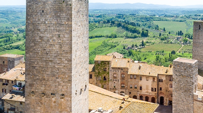 San Gimignano Civic Museum tower with Tuscan countryside in the background.