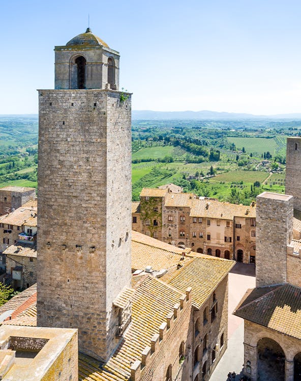 San Gimignano Civic Museum tower with Tuscan countryside in the background.