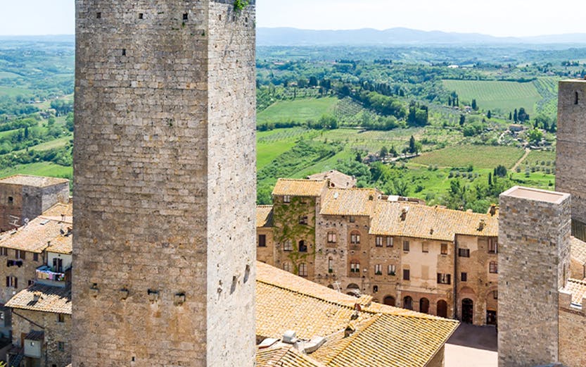 San Gimignano Civic Museum tower with Tuscan countryside in the background.