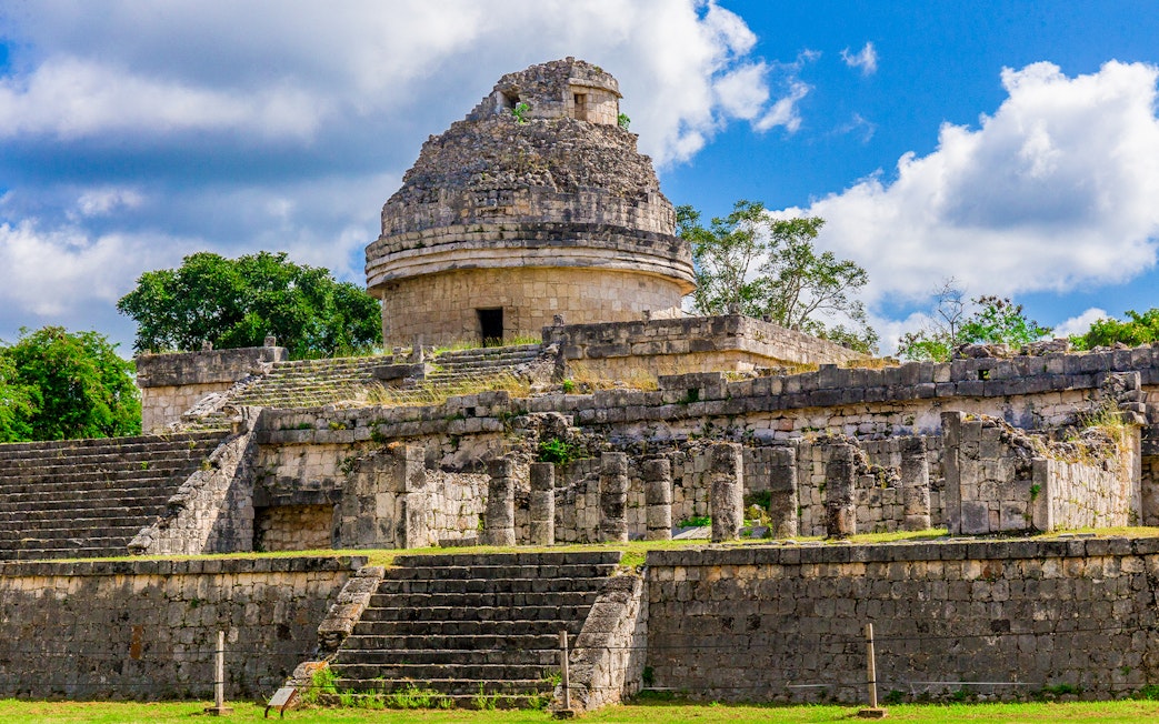 Weathered Mayan observatory at Chichen Itza, Mexico with stone steps and columns.