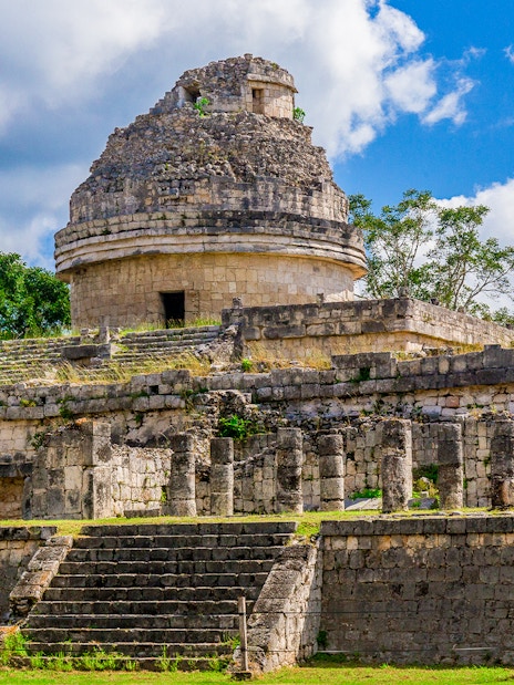 Weathered Mayan observatory at Chichen Itza, Mexico with stone steps and columns.