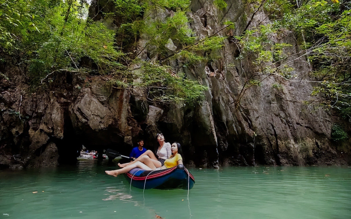 Canoeing through limestone cliffs at Talu Island, Thailand.