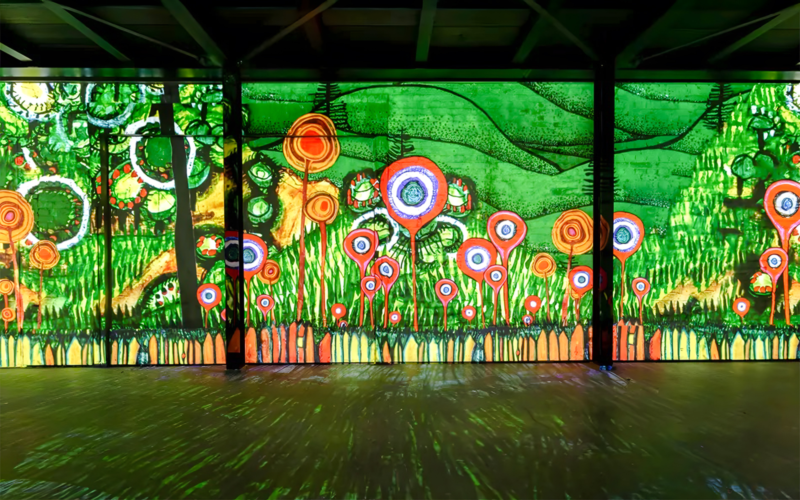 Hundertwasser artwork display at Port des Lumières, Hamburg, featuring vibrant abstract patterns.