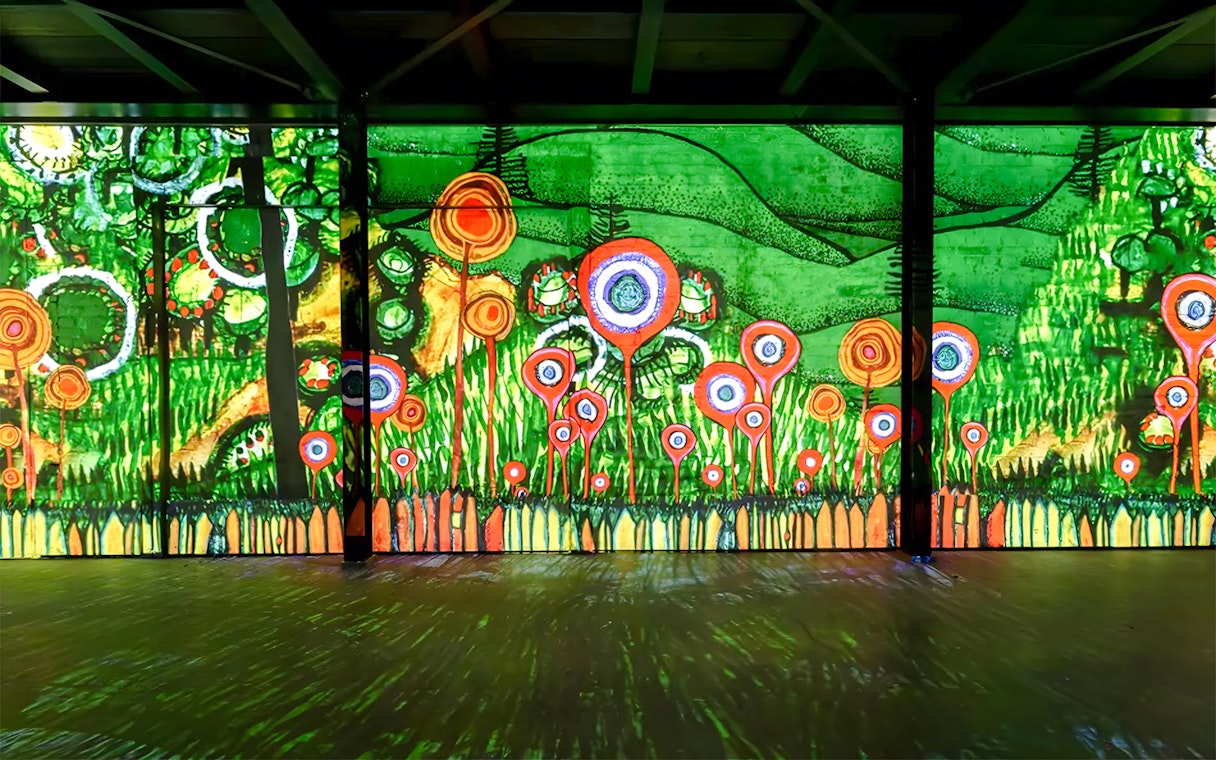 Hundertwasser artwork display at Port des Lumières, Hamburg, featuring vibrant abstract patterns.