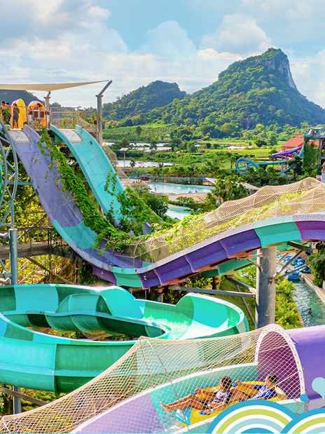 Water slides and attractions at Ramayana Water Park with lush greenery and mountain views.
