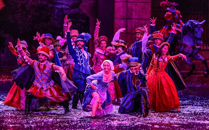 Performers in colorful period costumes during The Dream of Toledo Night Show.