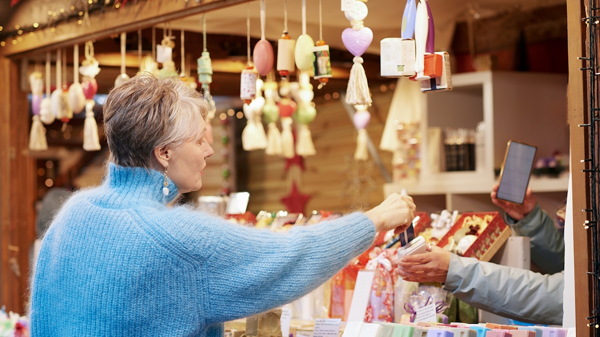Old woman buying soveniers from a gift shop in Mallorca