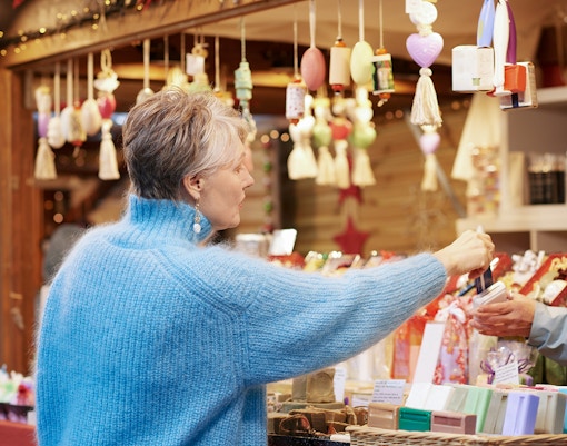 Old woman buying souveniers from a gift shop