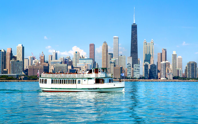 Chicago River cruise boat with city skyline in the background.
