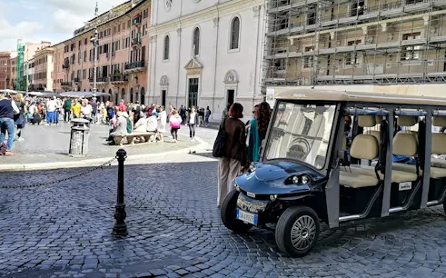 Golf cart parked in a busy Roman square during a night tour.
