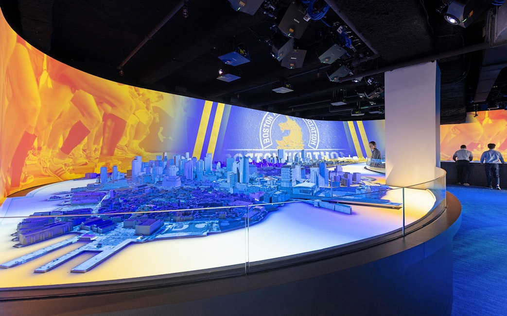 Boston city model with marathon imagery at an interactive exhibit.