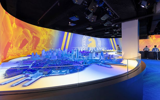 Boston city model with marathon imagery at an interactive exhibit.