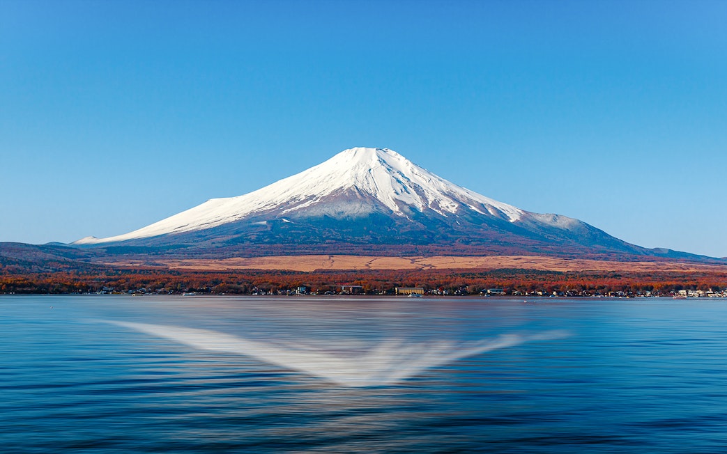 Mount Fuji reflected in Lake Kawaguchi on a clear day.