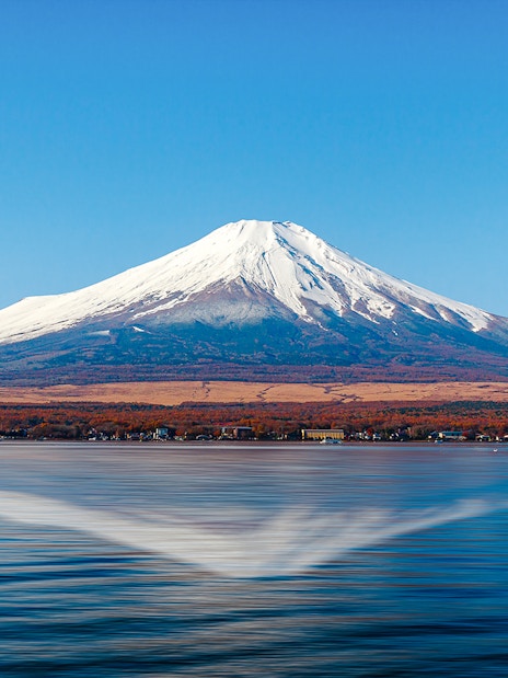 Mount Fuji reflected in Lake Kawaguchi on a clear day.
