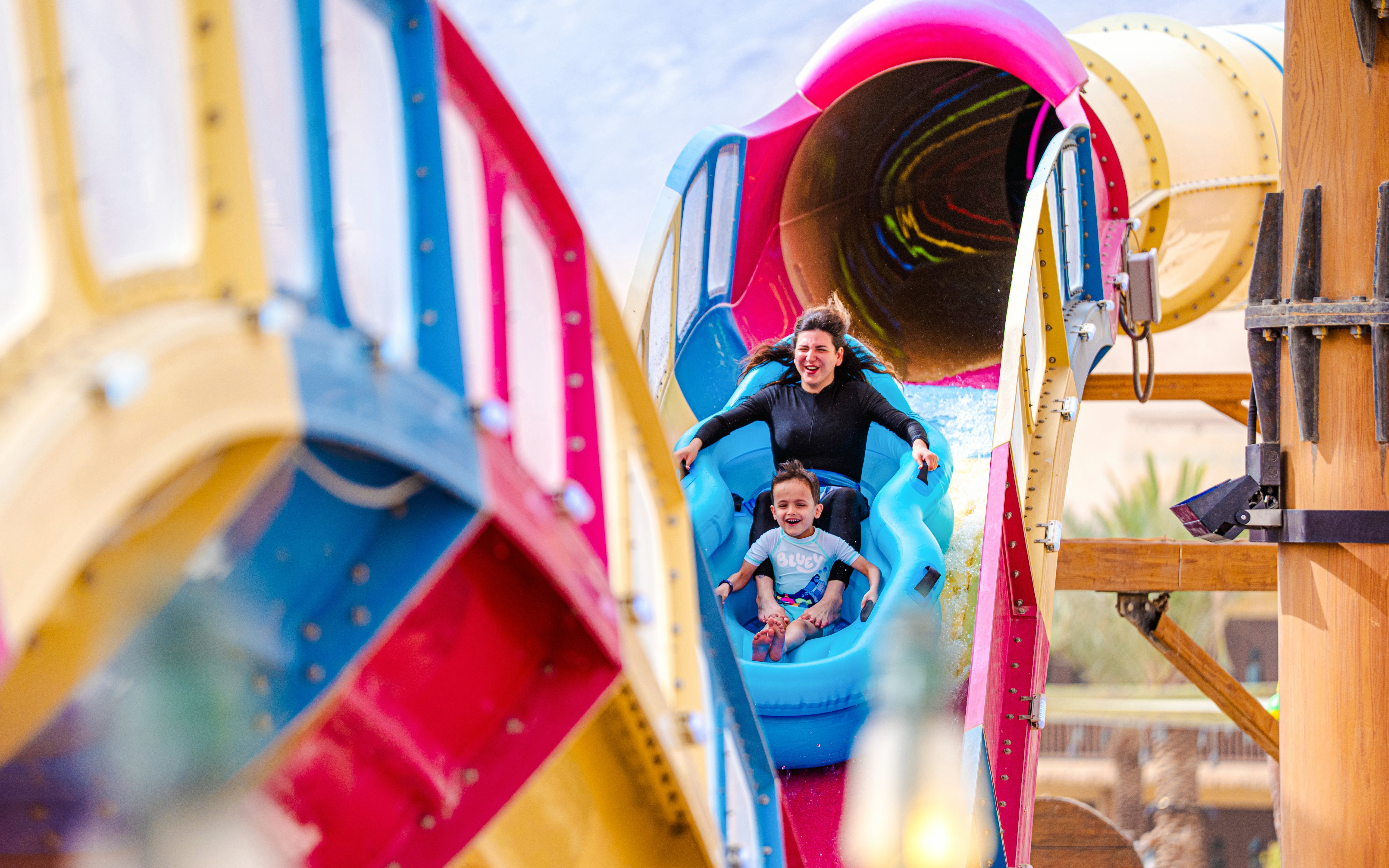 Mother and son on water slide at Aquarabia Qiddiya.
