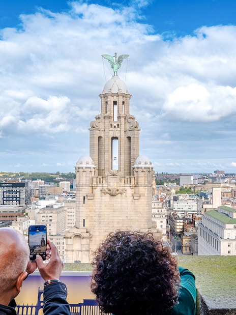 Guests photographing the Royal Liver Building in Liverpool.