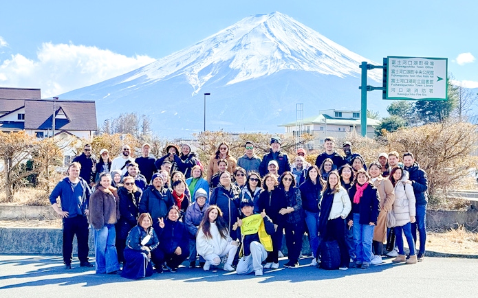 Tourists gathered in front of Mt. Fuji before boarding the Kachikachi Ropeway in Japan.