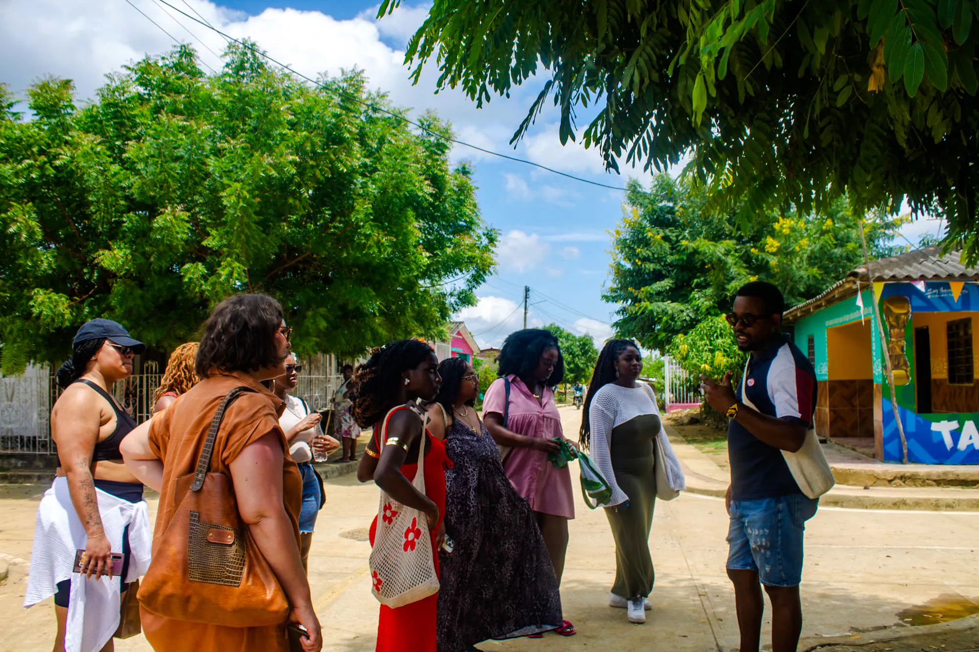 Tour group listening to a guide in San Basilio de Palenque, Cartagena.