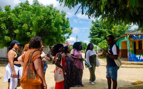 Tour group listening to a guide in San Basilio de Palenque, Cartagena.