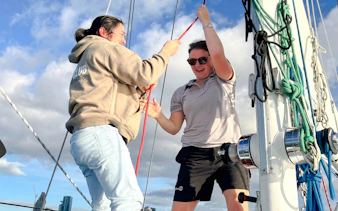 Sailors adjusting ropes on a yacht during Auckland Waitematā Harbour sailing cruise.