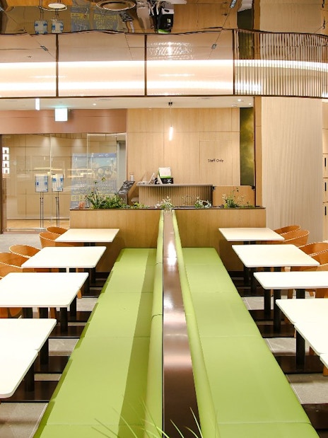 Wooden chairs and tables arranged at Plaza Premium Lounge, South Korea.