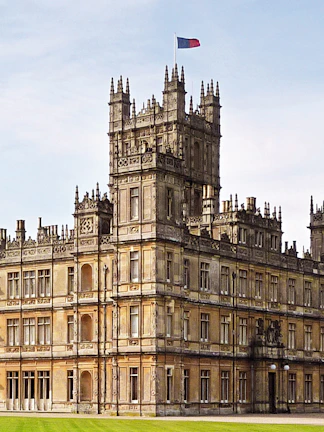 Highclere Castle, iconic setting for Downton Abbey, with a flag atop its tower.