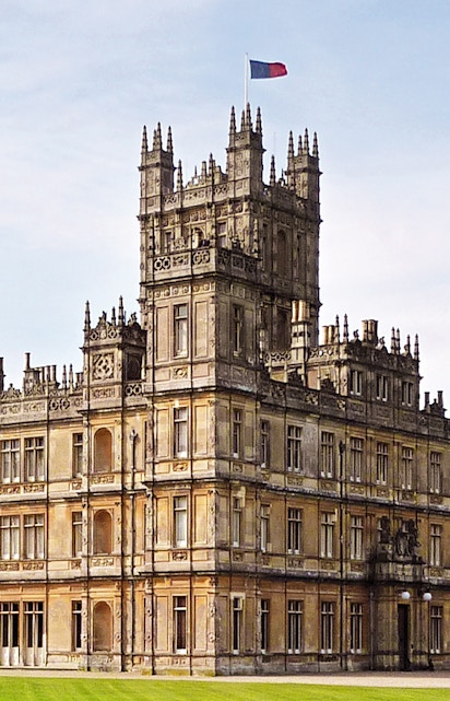 Highclere Castle, iconic setting for Downton Abbey, with a flag atop its tower.