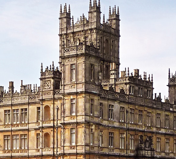 Highclere Castle, iconic setting for Downton Abbey, with a flag atop its tower.