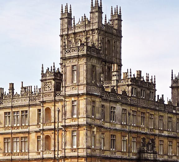 Highclere Castle, iconic setting for Downton Abbey, with a flag atop its tower.