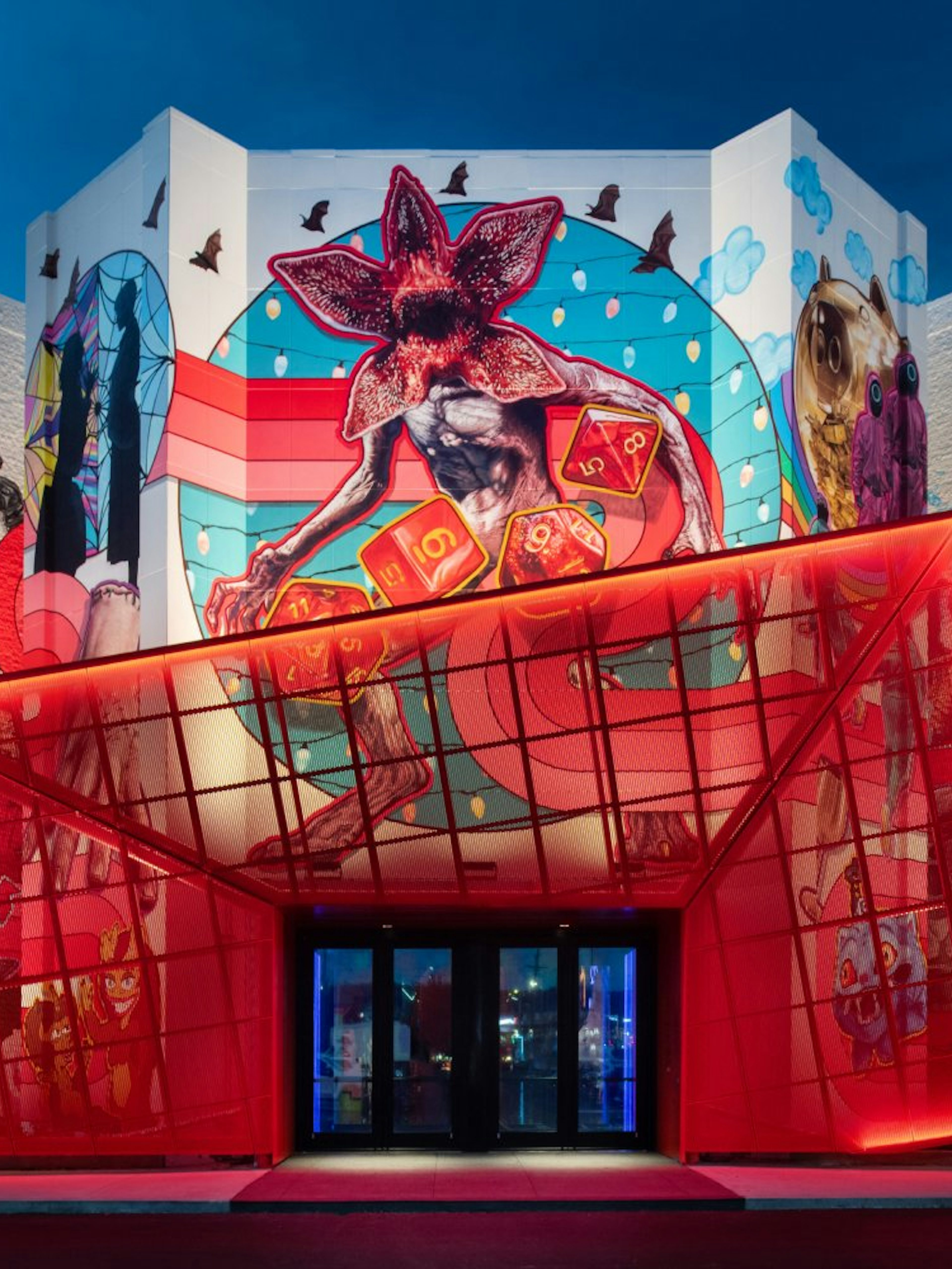 Colorful mural with fantasy creatures on the facade of Netflix House, Philadelphia.