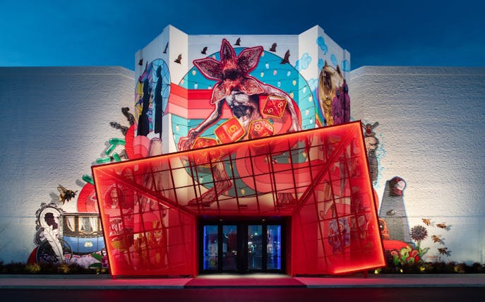 Colorful mural with fantasy creatures on the facade of Netflix House, Philadelphia.