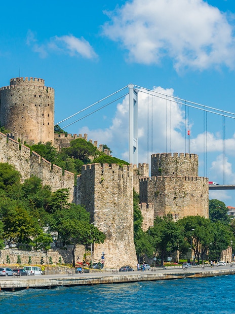 Rumeli Fortress along the Bosphorus with a bridge in Istanbul, Turkey.