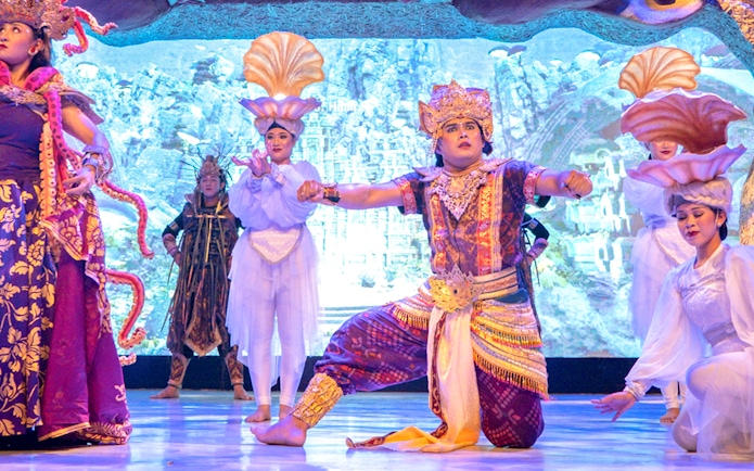 Traditional Balinese dancers performing at Garuda Wisnu Kencana at night.
