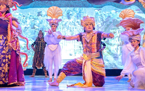 Traditional Balinese dancers performing at Garuda Wisnu Kencana at night.