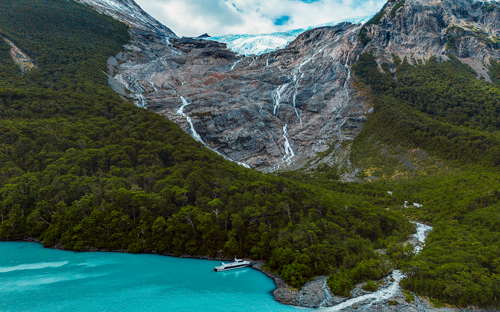Balmaceda Glacier with turquoise lake and boat in Patagonia, Chile, within Los Glaciares National Park.