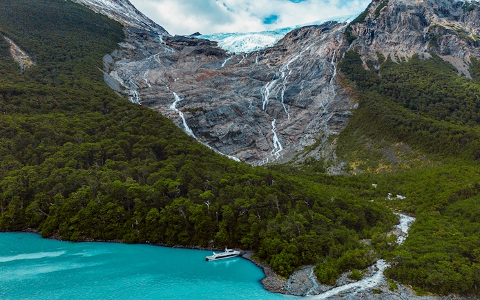 Balmaceda Glacier with turquoise lake and boat in Patagonia, Chile, within Los Glaciares National Park.