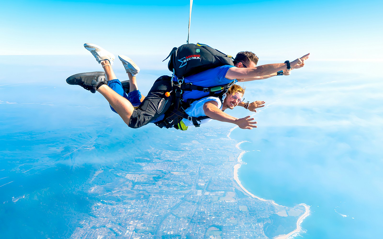 An instructor and a guest skydiving over Wollongong