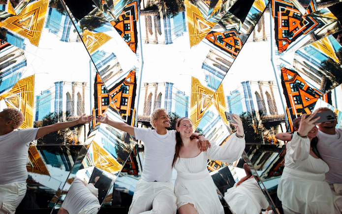 Visitors taking a selfie inside the mirrored interior of Edge Observatory, New York.